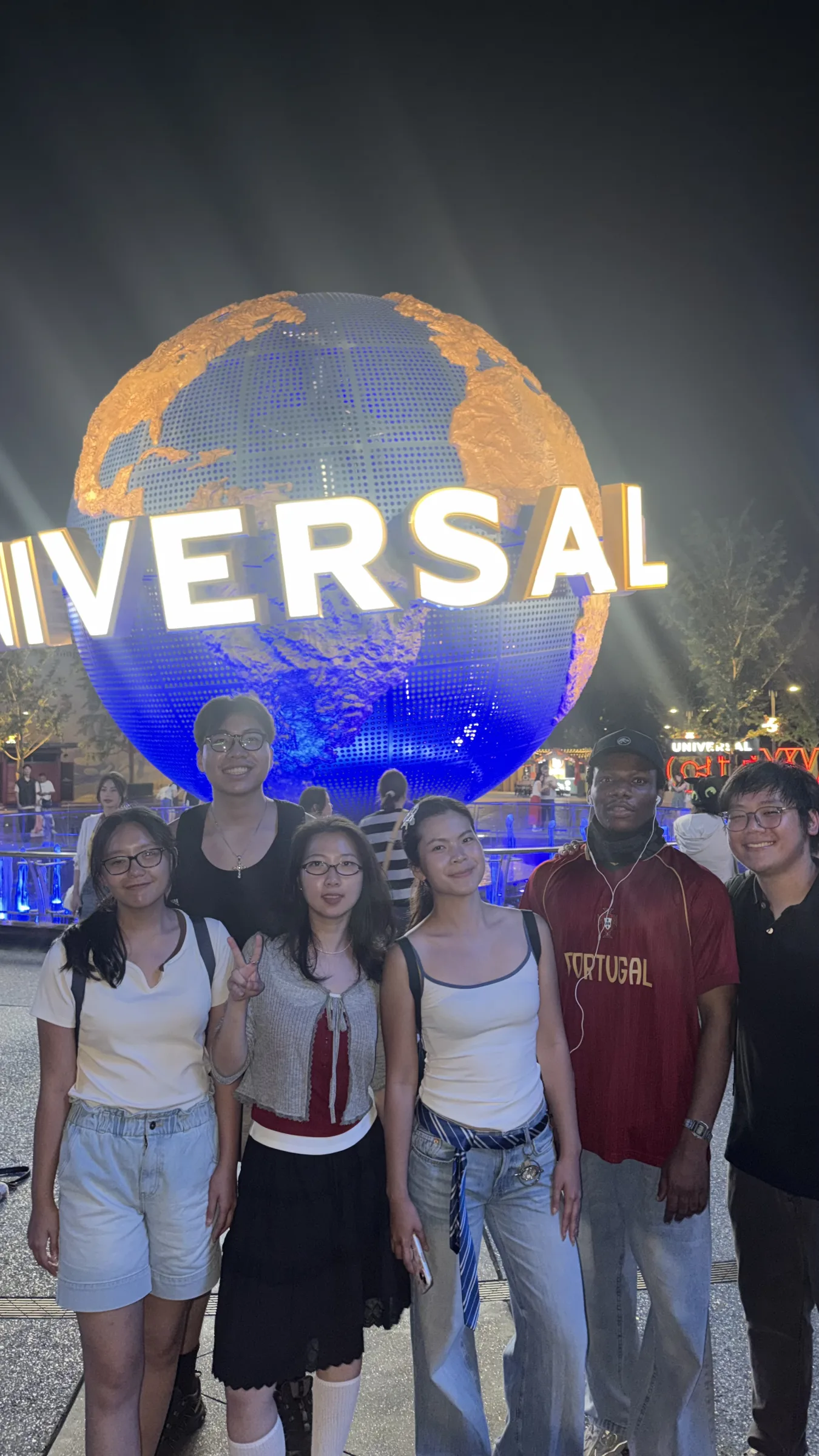 The group at the Universal Studios globe at night