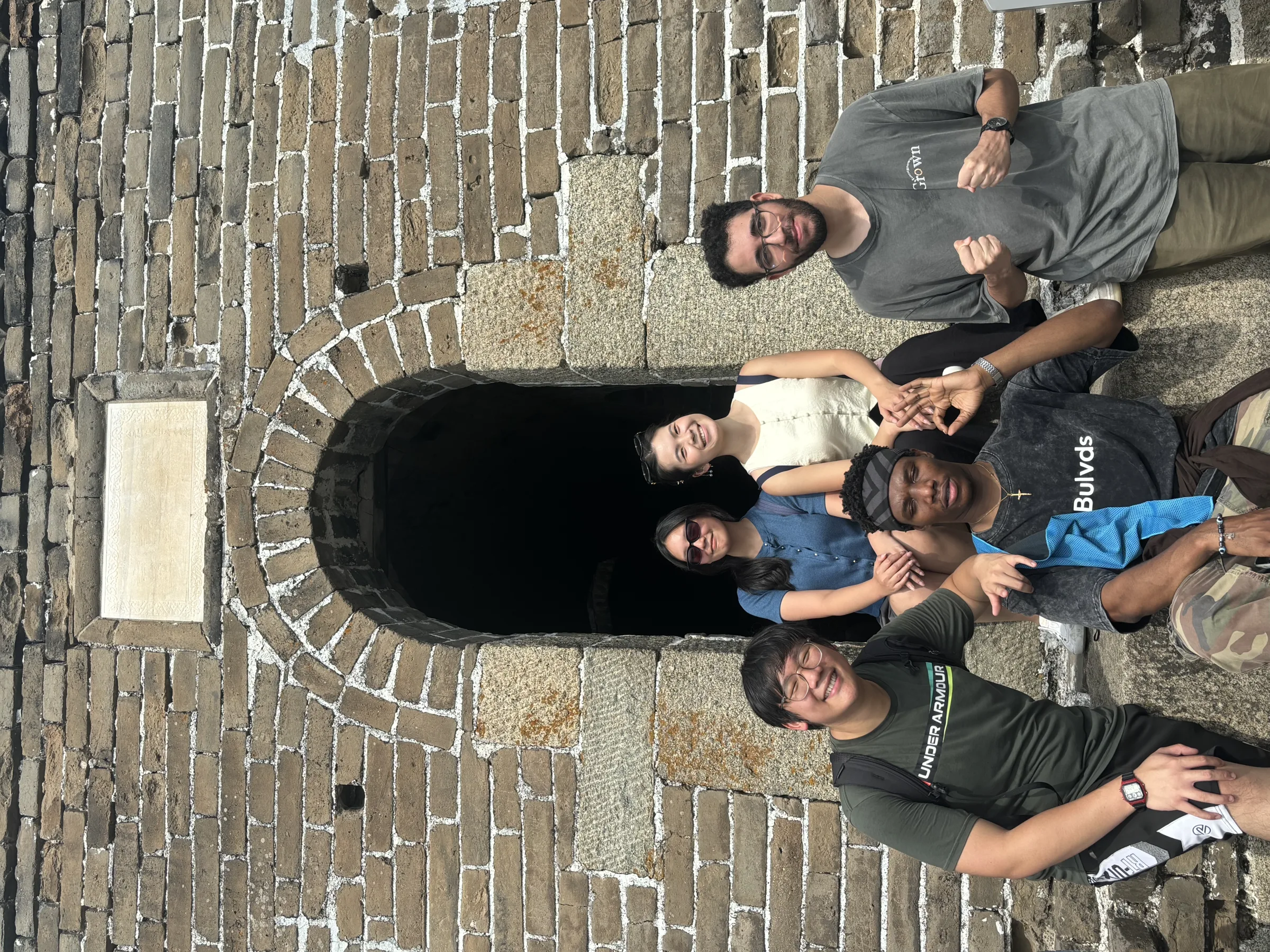 Members posing together in a stone archway