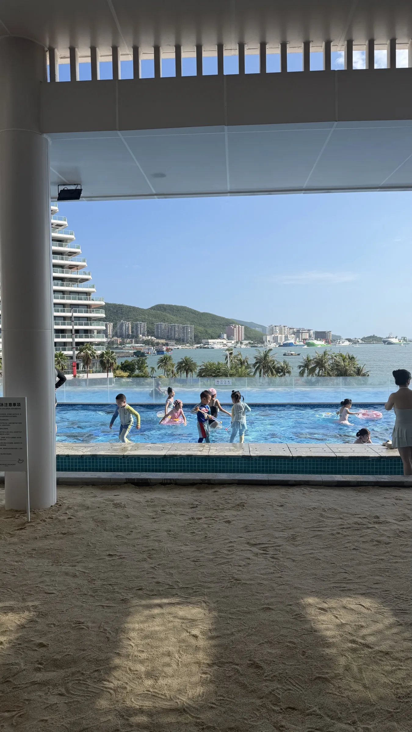 A resort pool seen from the beach