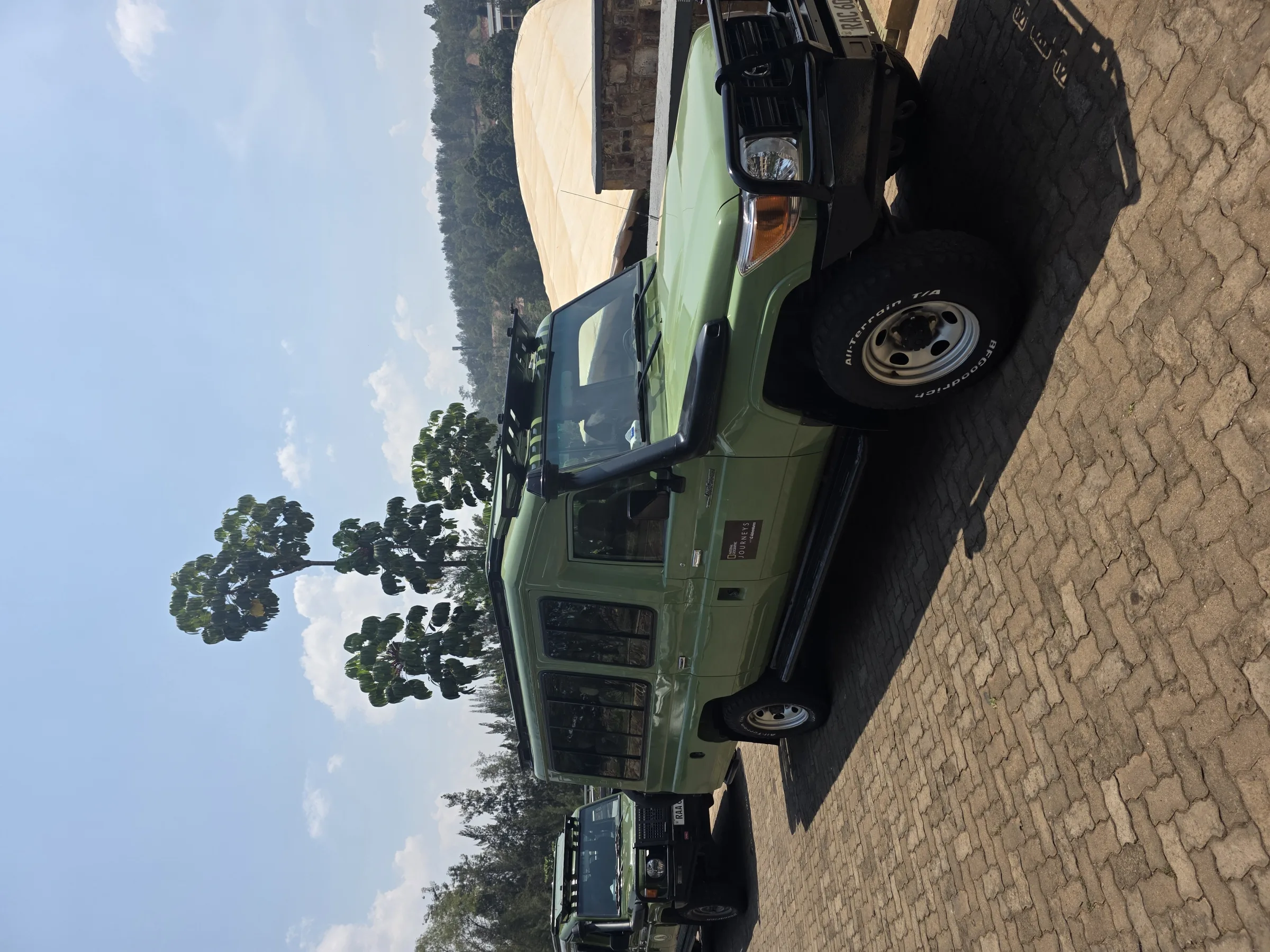 A safari jeep parked on cobblestones