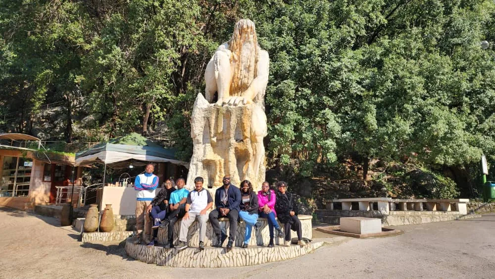The group seated around a stone horse monument