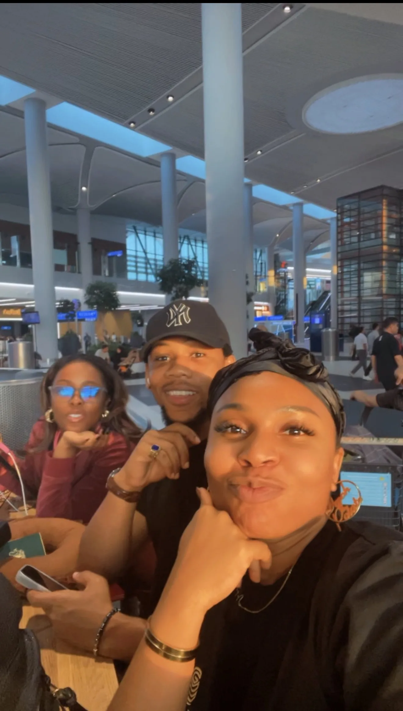 Members waiting together in the airport terminal
