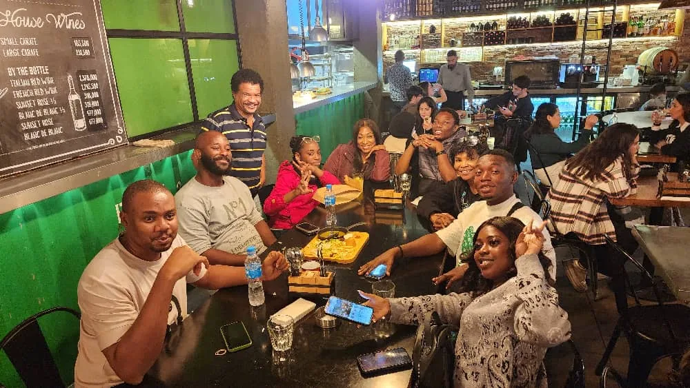 Members around a long table at dinner on a trip evening