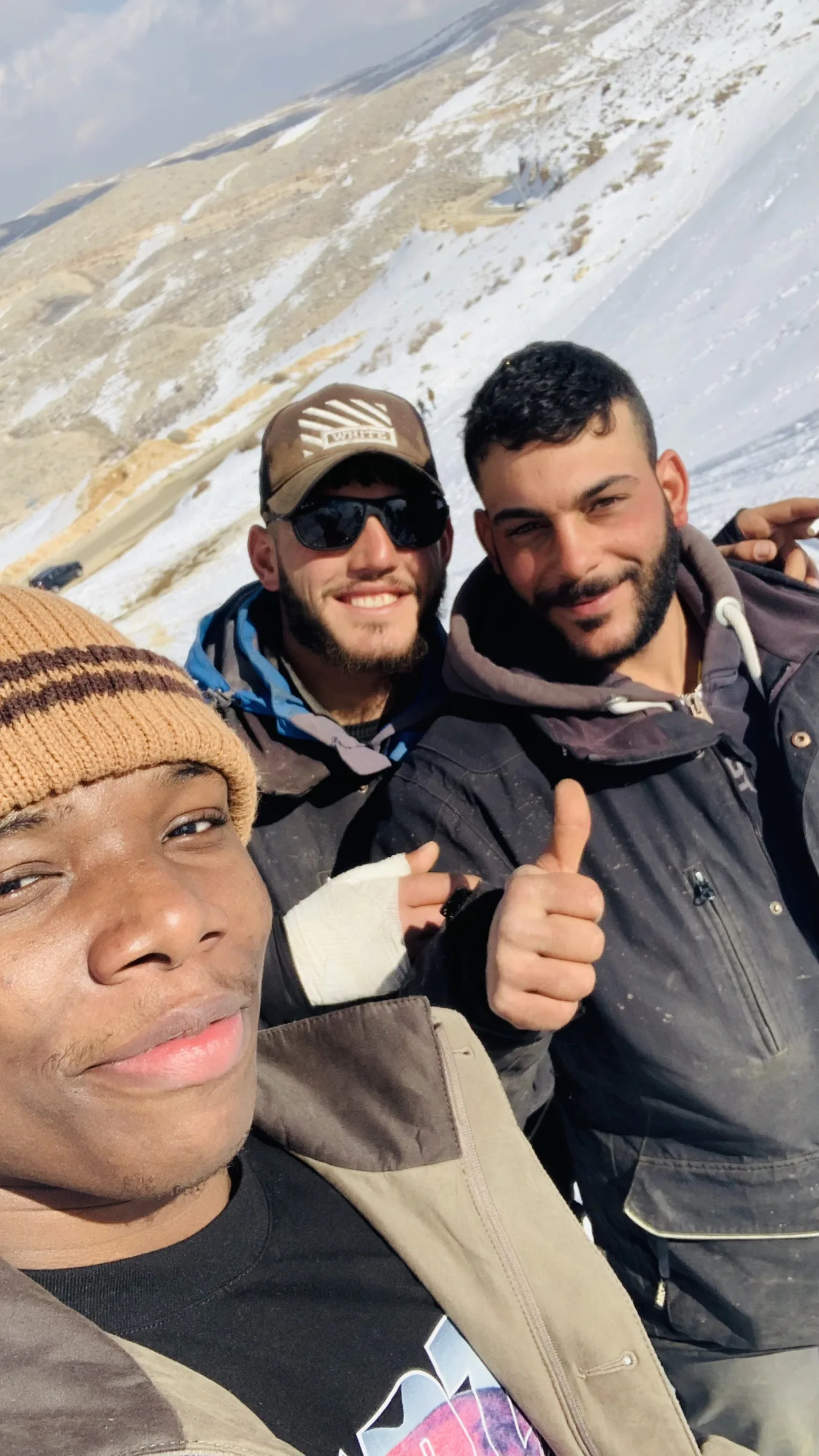 Two members in the snow, thumbs up for the camera