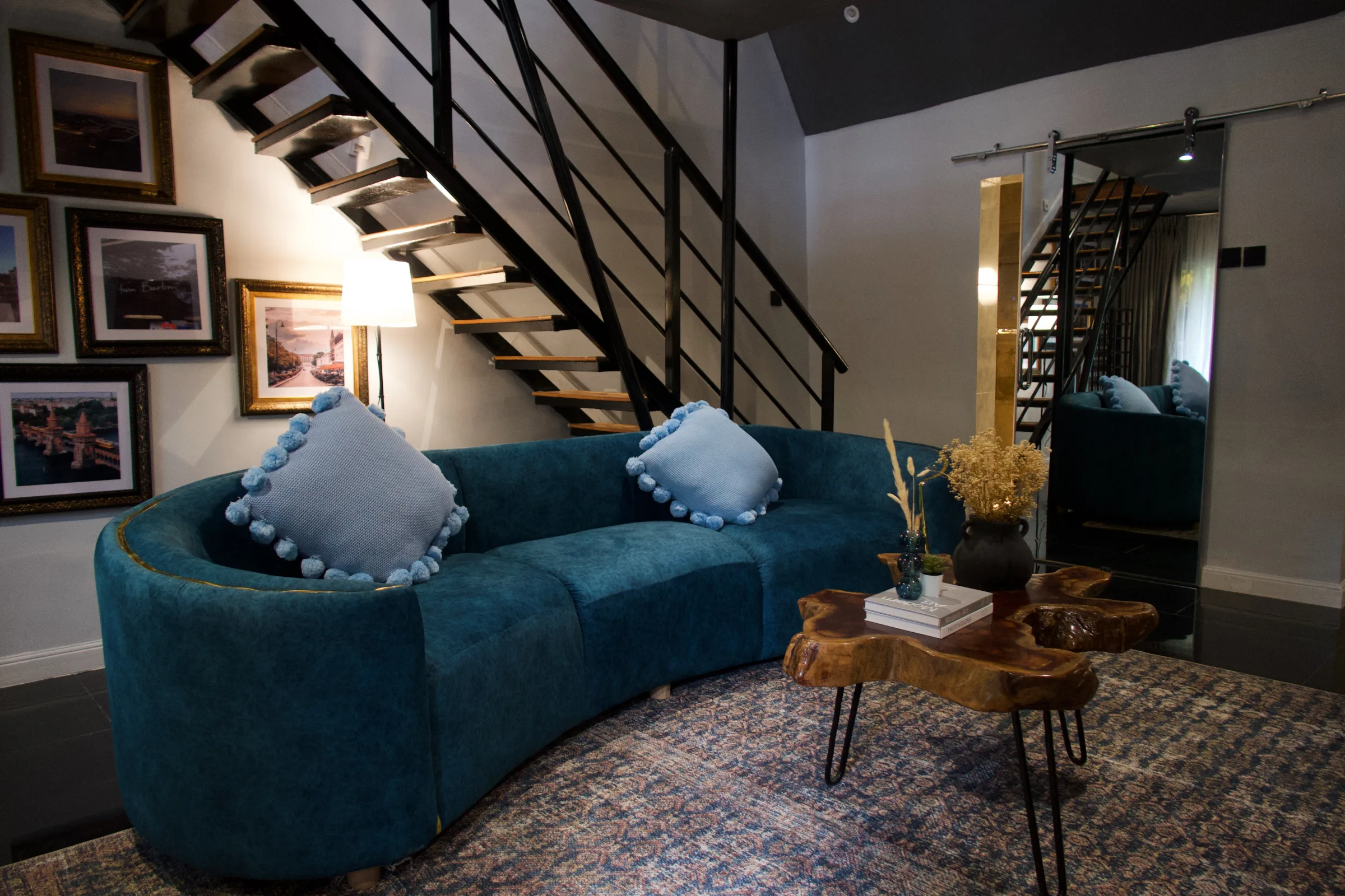 A hotel lounge with a deep green velvet sofa