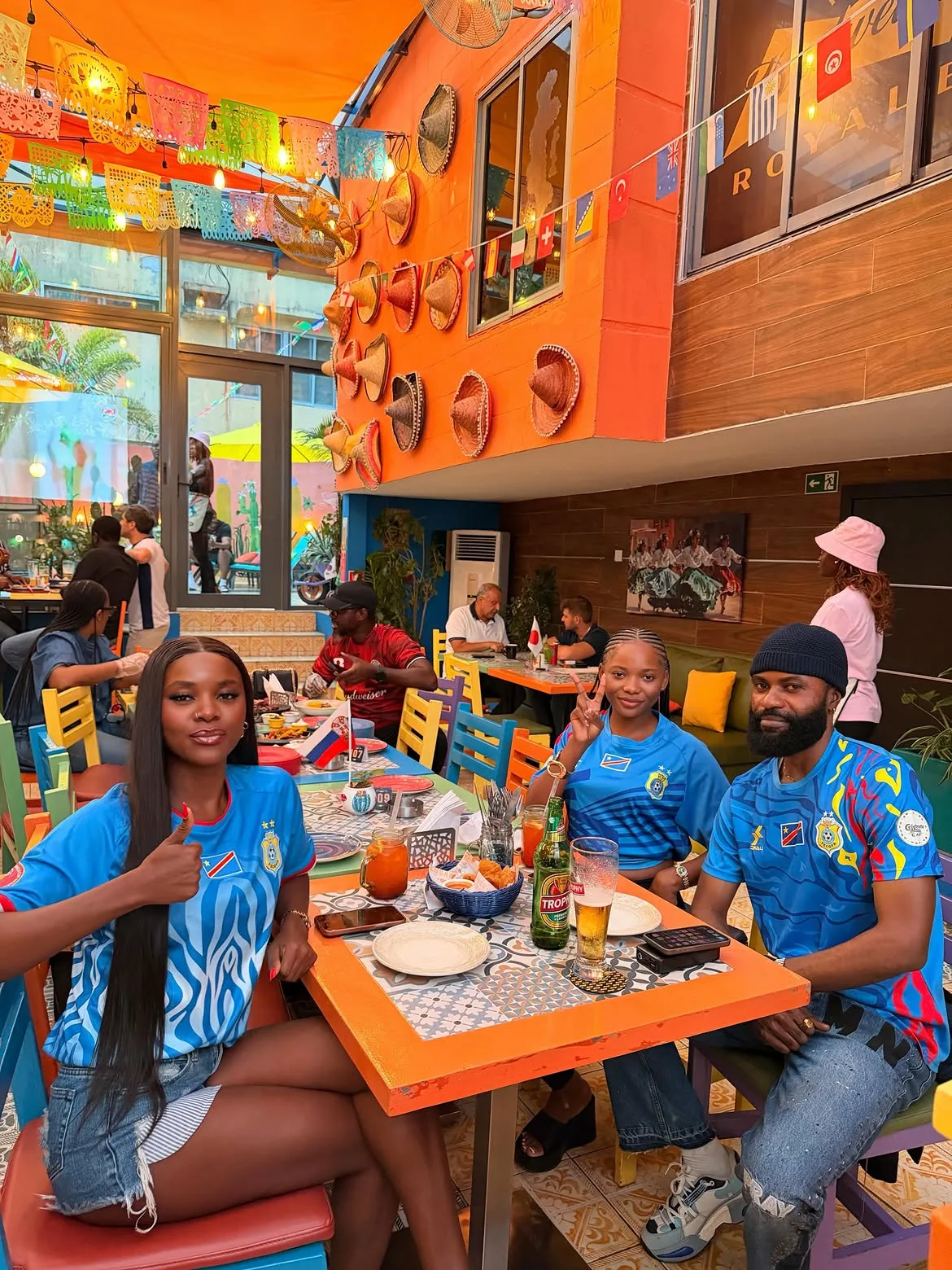 Members at a bright restaurant table in matching jerseys